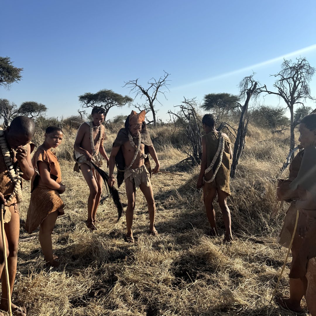 San Bushmen at Moela walking through the winter bush, seen from behind